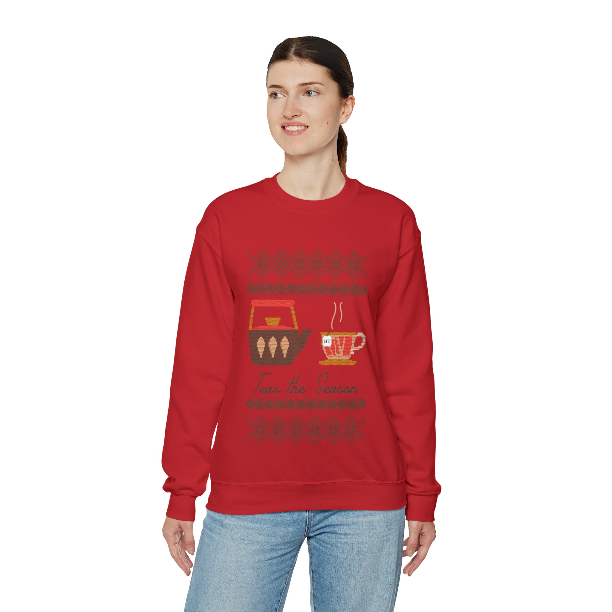 Red holiday sweater featuring a festive "Teas The Season" graphic with tea cups and ornaments. Perfect for winter celebrations.
