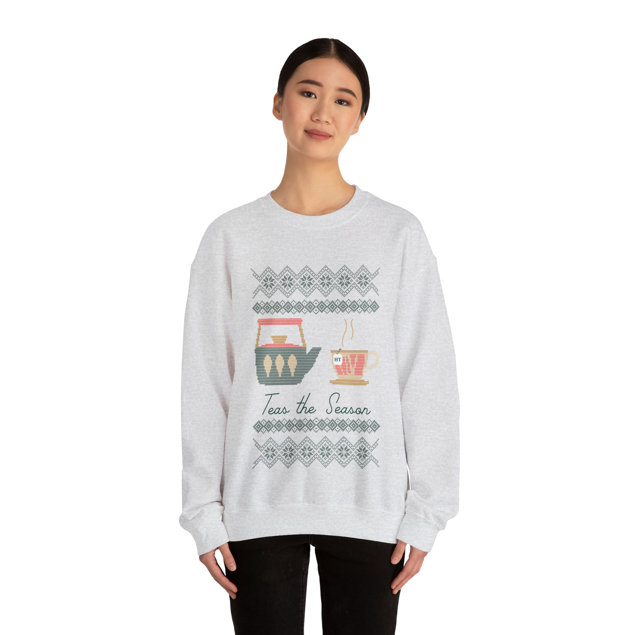 Cozy gray holiday sweater featuring "Teas the Season" graphic with festive tea cups and winter patterns.