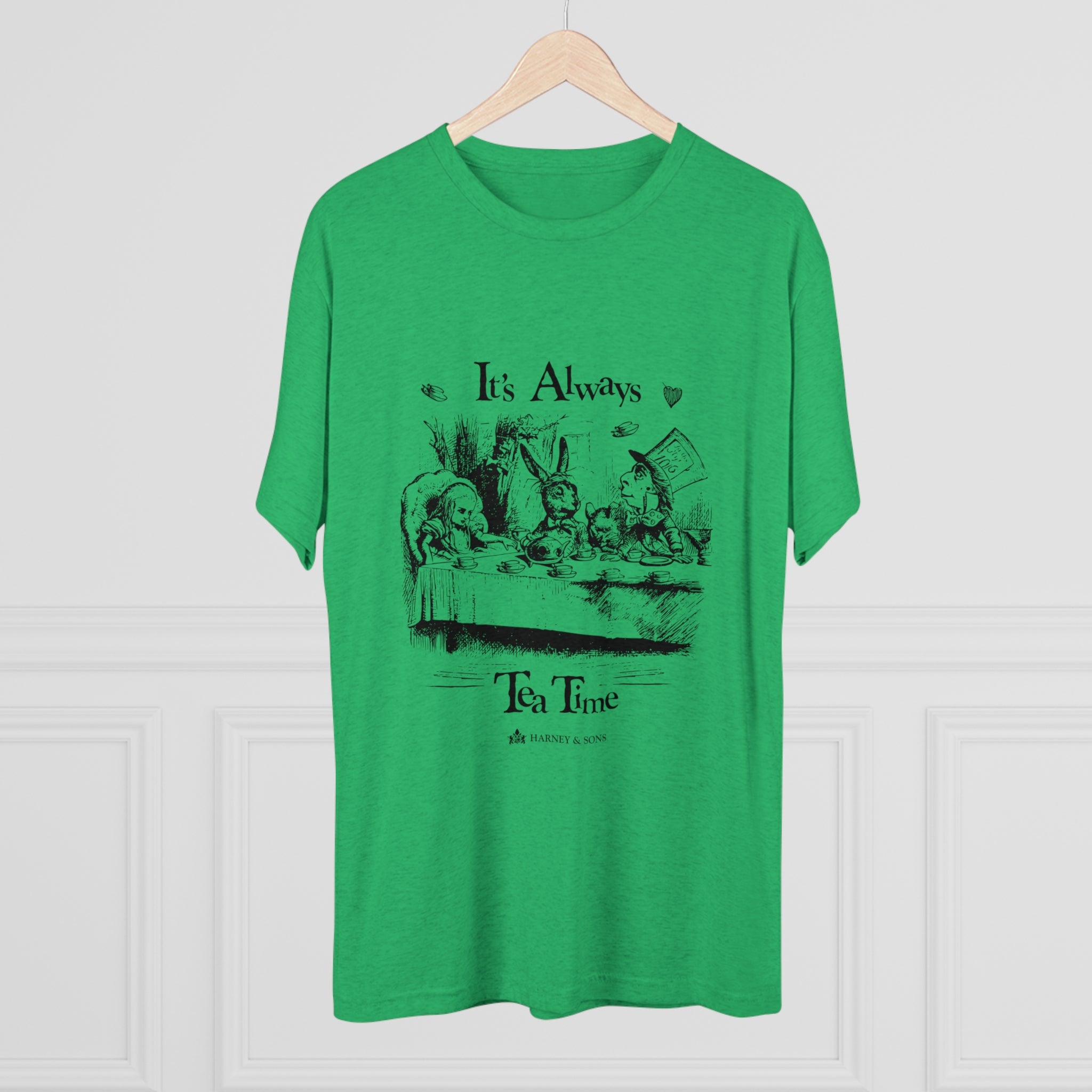 Green graphic tee featuring "It's Always Tea Time" design with whimsical tea party illustration. Perfect for tea lovers.