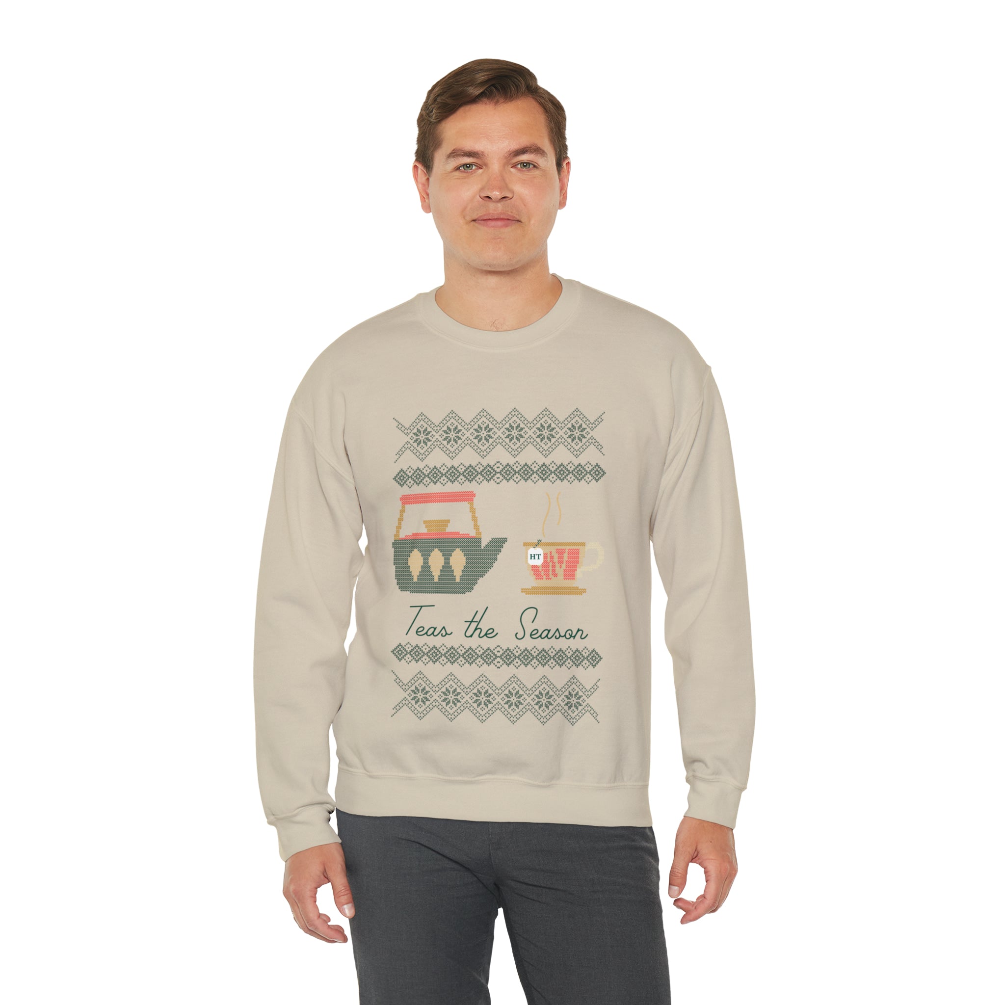 Man wearing a beige "Teas The Season" holiday sweater featuring festive tea-themed graphics.