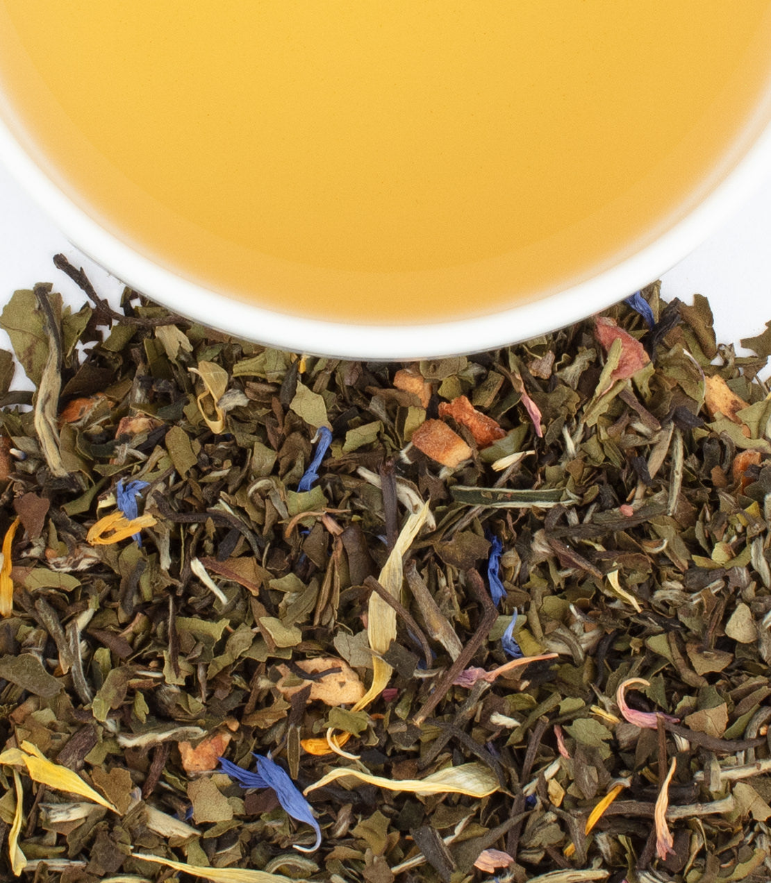 "Snow White tea sachets with loose leaf blend and brewed tea in a cup, showcasing vibrant colors and textures.