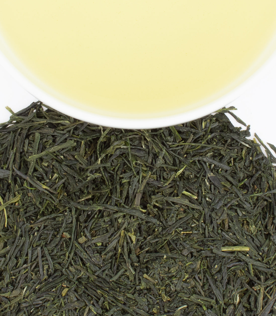 Master's Mark Sencha green tea leaves with a cup of brewed tea, showcasing vibrant color and texture.