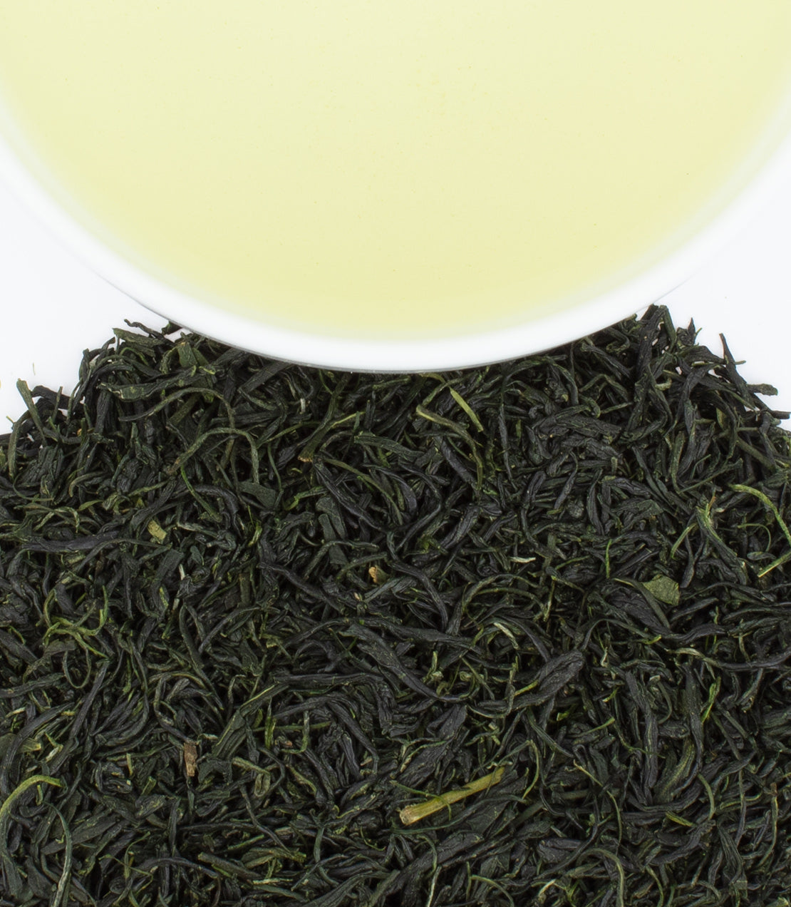 Wazuka Guricha green tea leaves with a cup of pale green tea above, showcasing its vibrant color and texture.