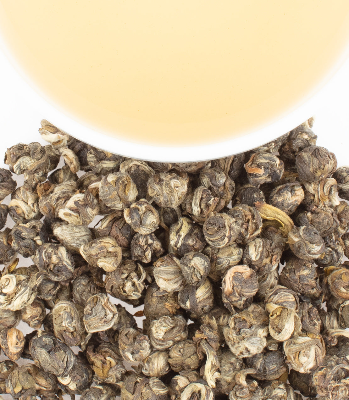 Classic tin of Dragon Pearl Jasmine tea sachets with rolled tea pearls and brewed tea in a cup.