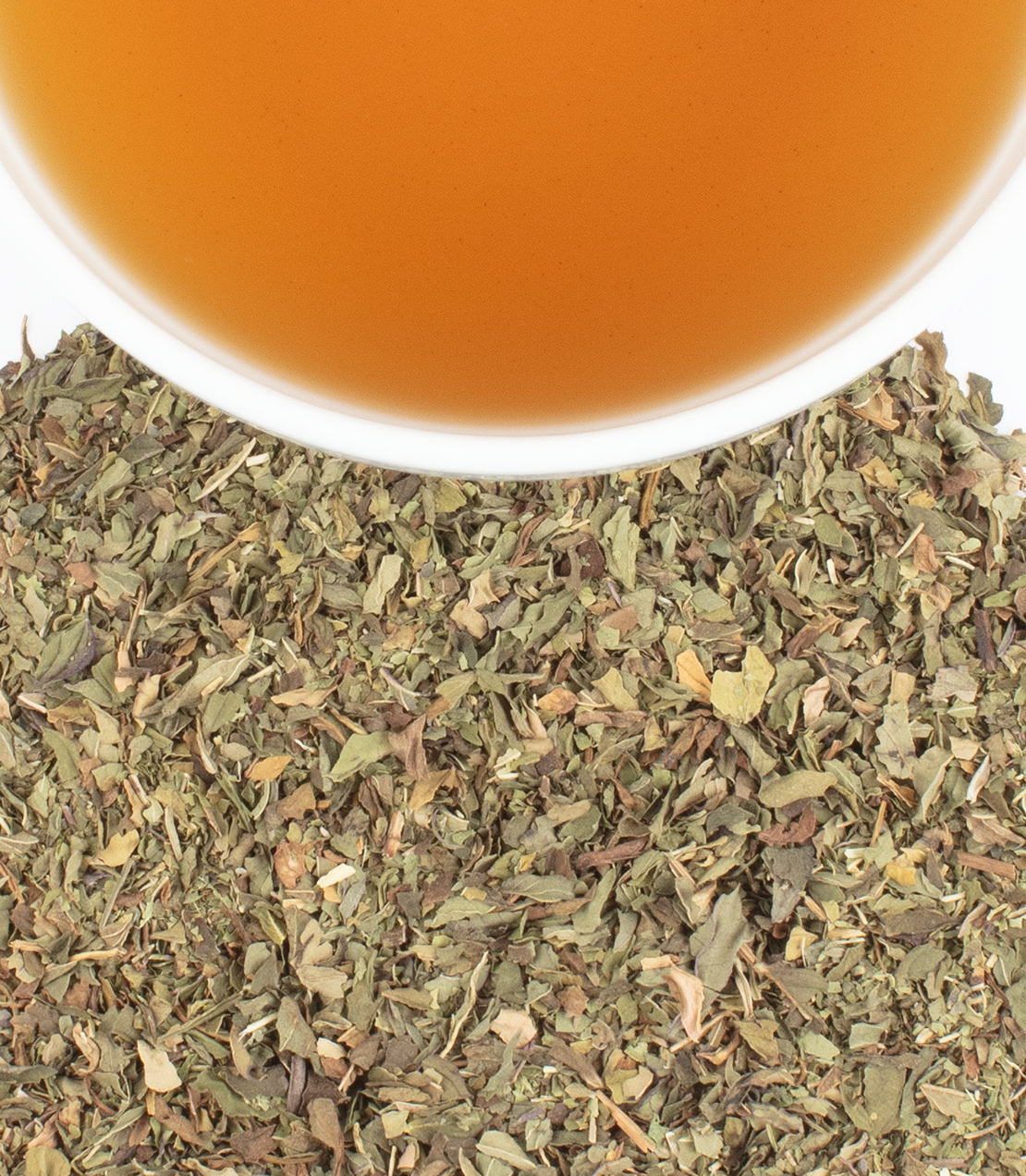 Dried mint verbena leaves with a cup of brewed tea above, showcasing herbal infusion and natural ingredients.