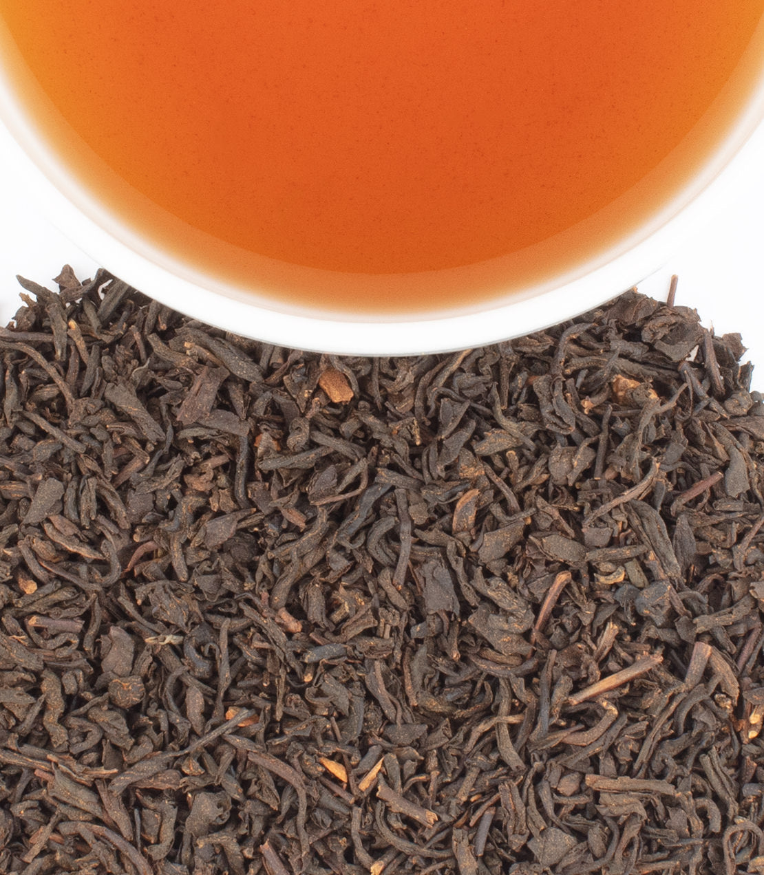 Continental Breakfast tea sachets with brewed tea in a cup, showcasing rich black tea leaves.
