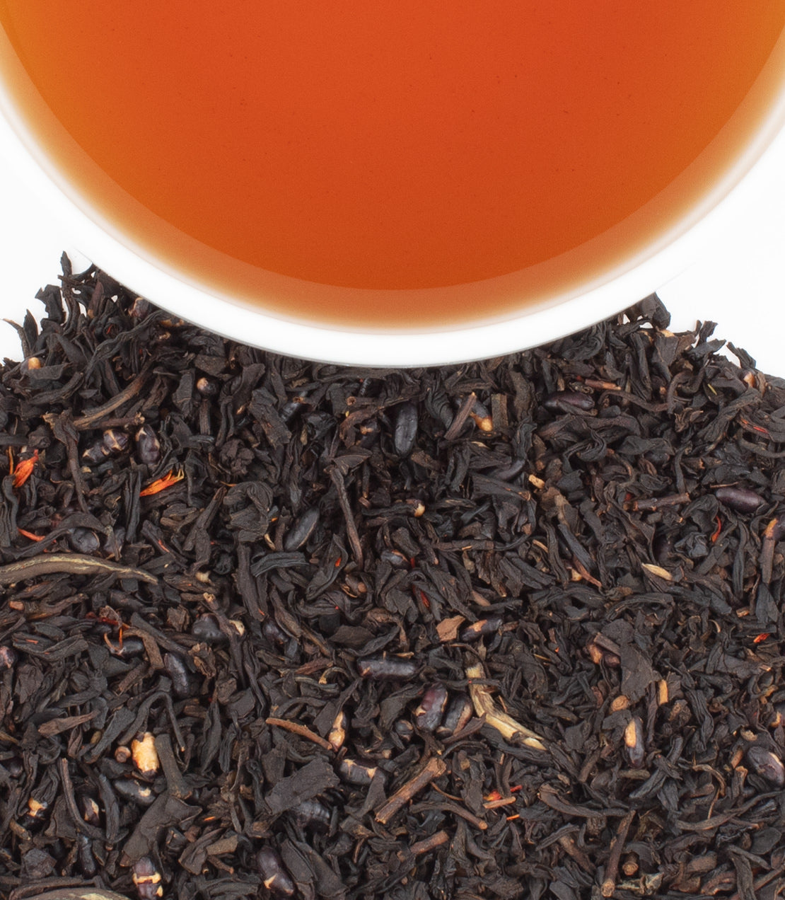 Tin of Sweet Azuki Black tea sachets with brewed tea in a cup and loose tea leaves displayed.