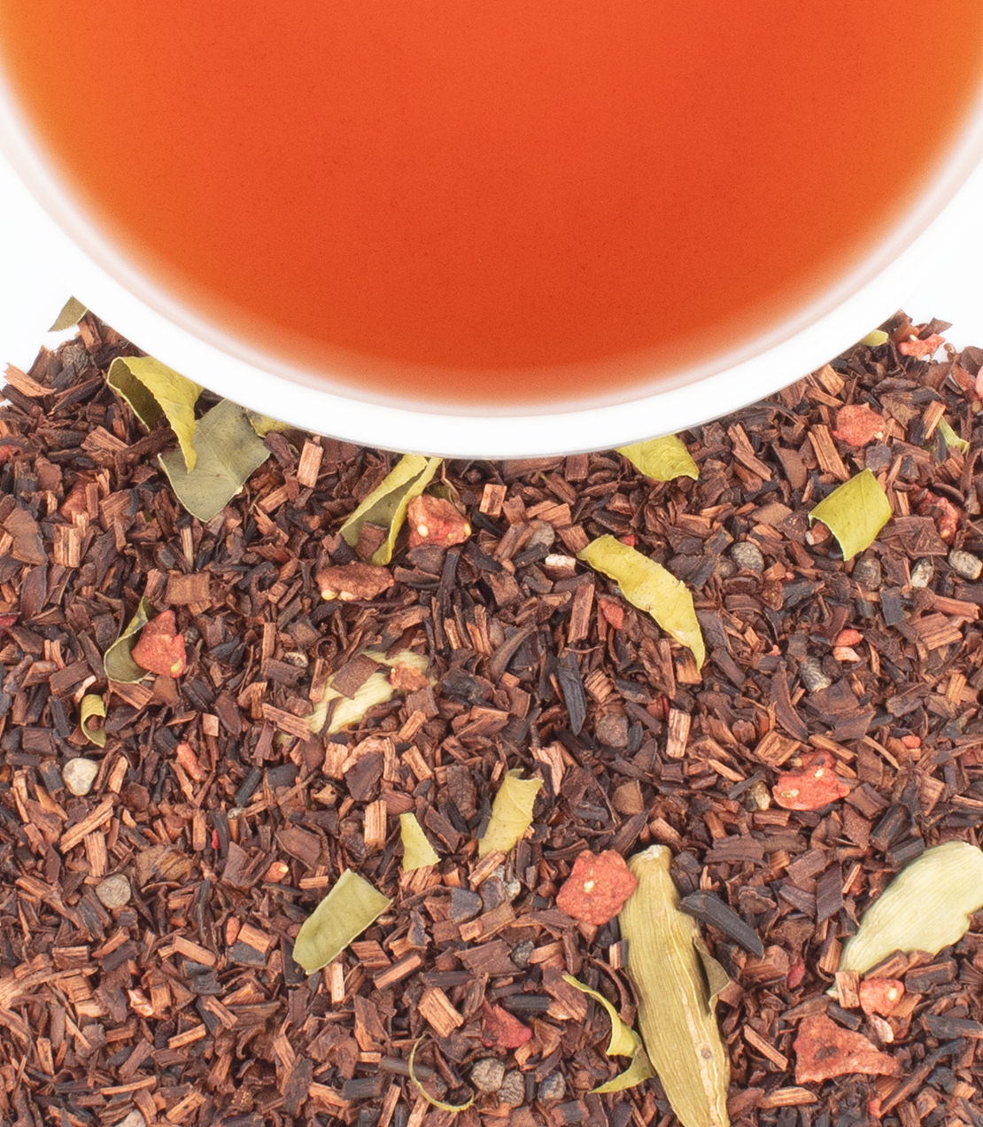 Tin of 20 sachets of Wellness in the Cup tea, with brewed tea and loose herbal ingredients displayed.