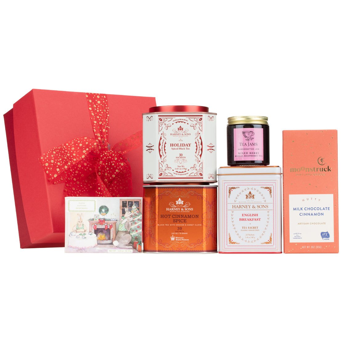Festive gift box featuring assorted teas, chocolates, and a holiday card, beautifully wrapped in red.