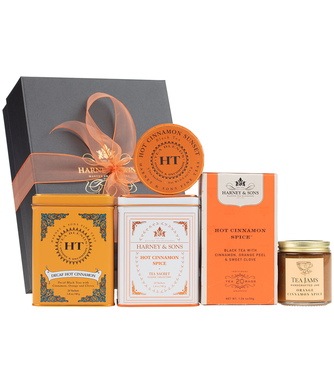 Hot Cinnamon Spice Tea gift set featuring tea tins, tea jam, and a decorative box with an orange ribbon.