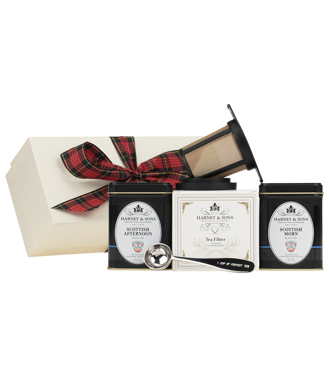"Scottish gift set featuring Harney & Sons tea, a tea filter, and a scoop in a decorative box with tartan ribbon.