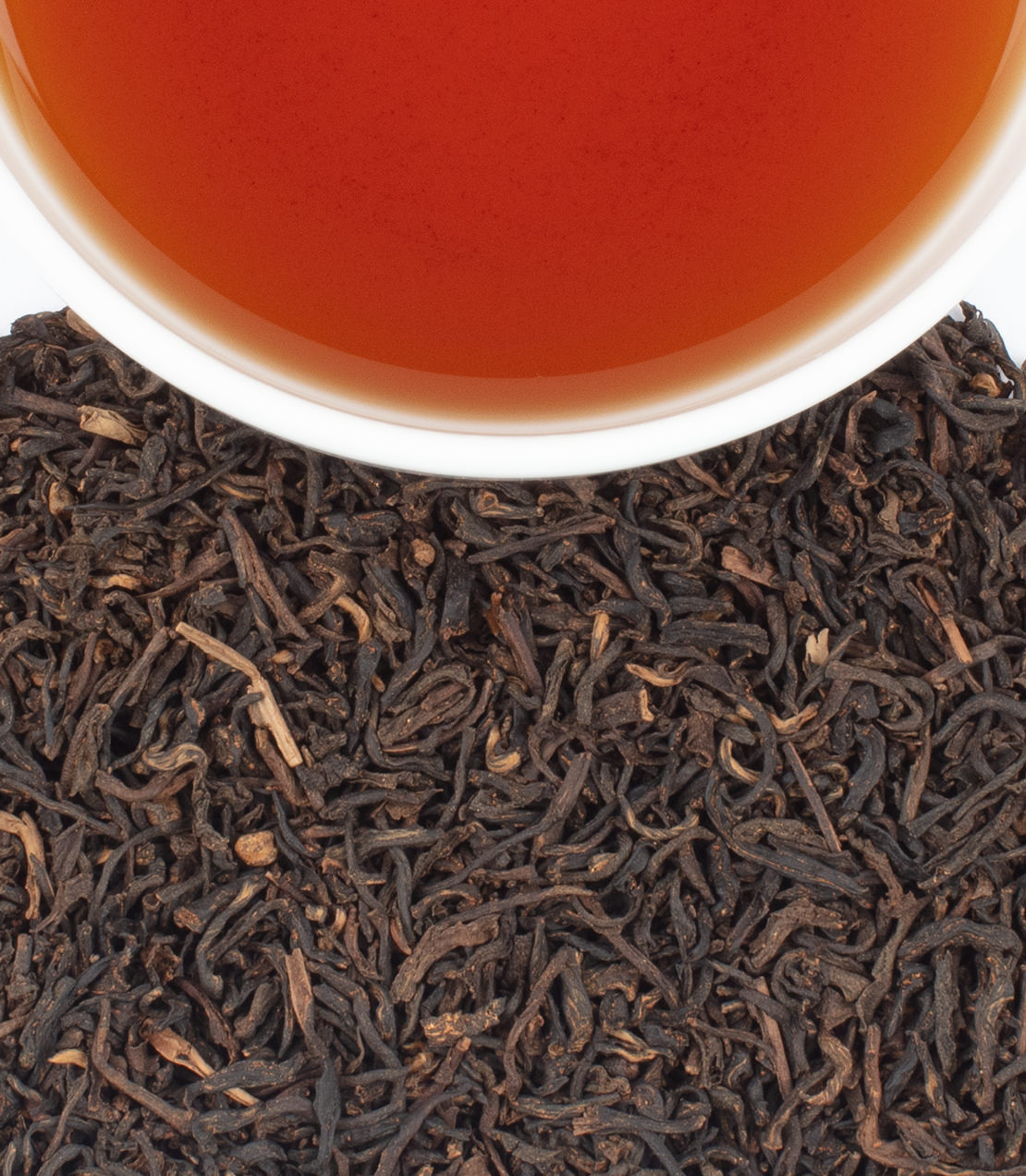 Harney & Sons Fine Teas- Brewed cup of Decaffeinated Chai tea with dry chai tea leaves below