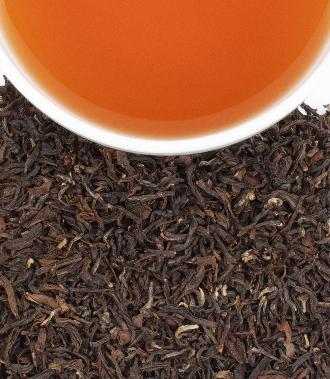 Sungma 2nd Flush tea leaves with a cup of brewed tea, showcasing rich color and aroma. Perfect for tea enthusiasts.