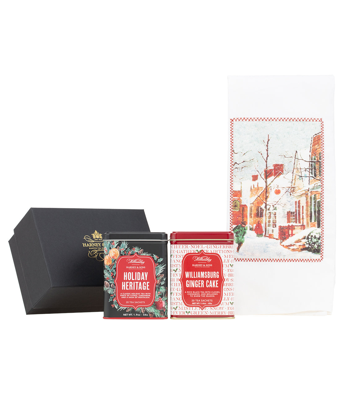 Harney & Sons Fine Teas- Williamsburg Duo with Towel Gift- Two tea tins labeled 'Williamsburg Ginger Cake' and 'Holiday Heritage'- Towel with town in winter scene- black box with gold Harney & Sons Logo