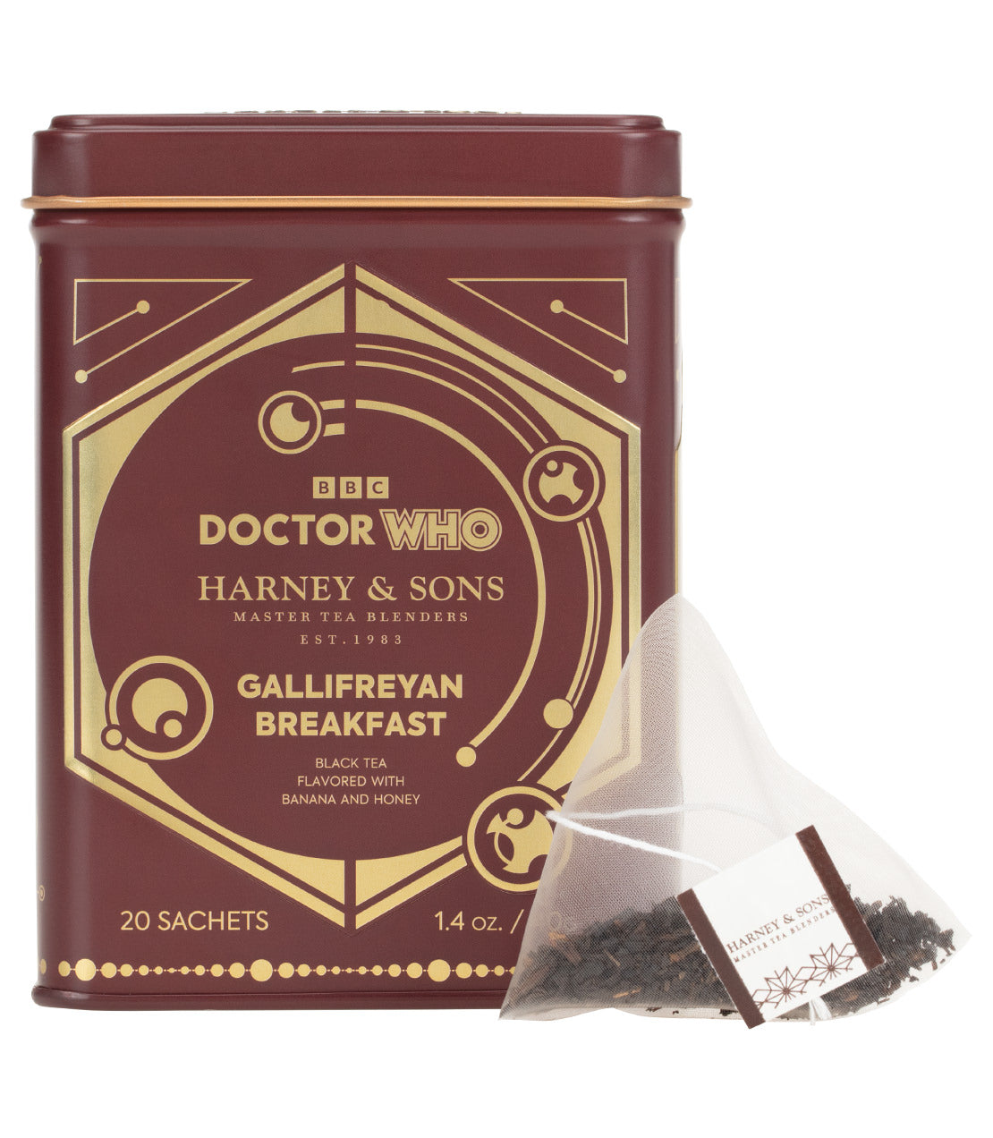 Doctor Who Harney & Sons Gallifreyan Breakfast black tea by Harney & Sons, shown in a dark reddish-brown metal tin with gold detailing, alongside a single triangular sachet of tea on a white background.