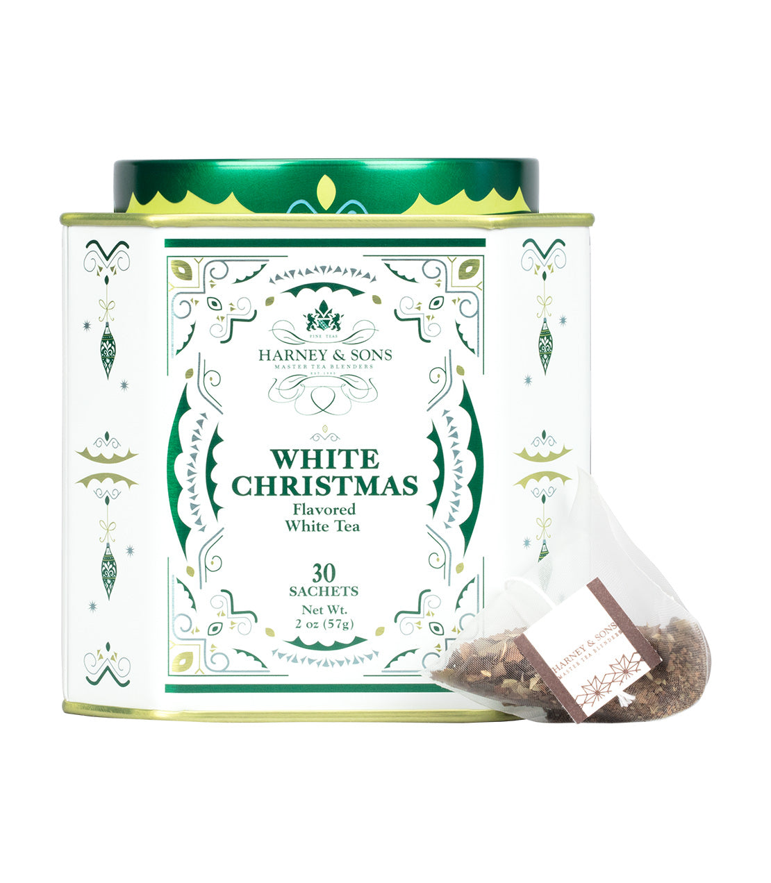 Harney & Sons White Christmas Flavored White Tea, featuring a round white tin canister with green and gold decorative borders and a single sachet in the foreground.