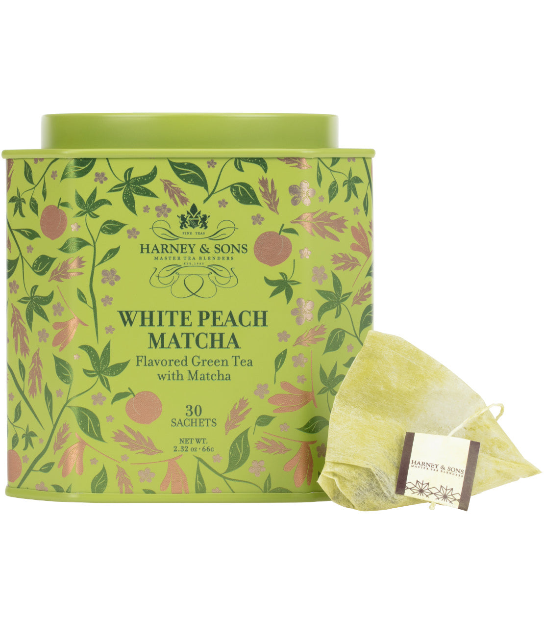 Harney & Sons Fine Teas- White Peach Matcha- Flavored Green Tea with Matcha- Icon Collection- Green tin of 30 sachets featuring leaves, flowers, and peaches- Pictured behind pyramidal sachet