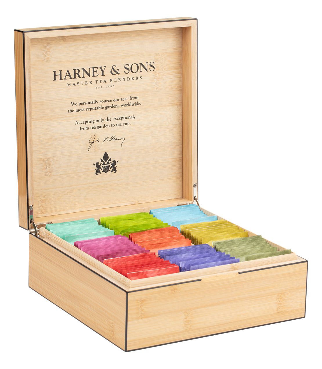 An open bamboo box from Harney & Sons, displaying colorful teabags arranged in rows.