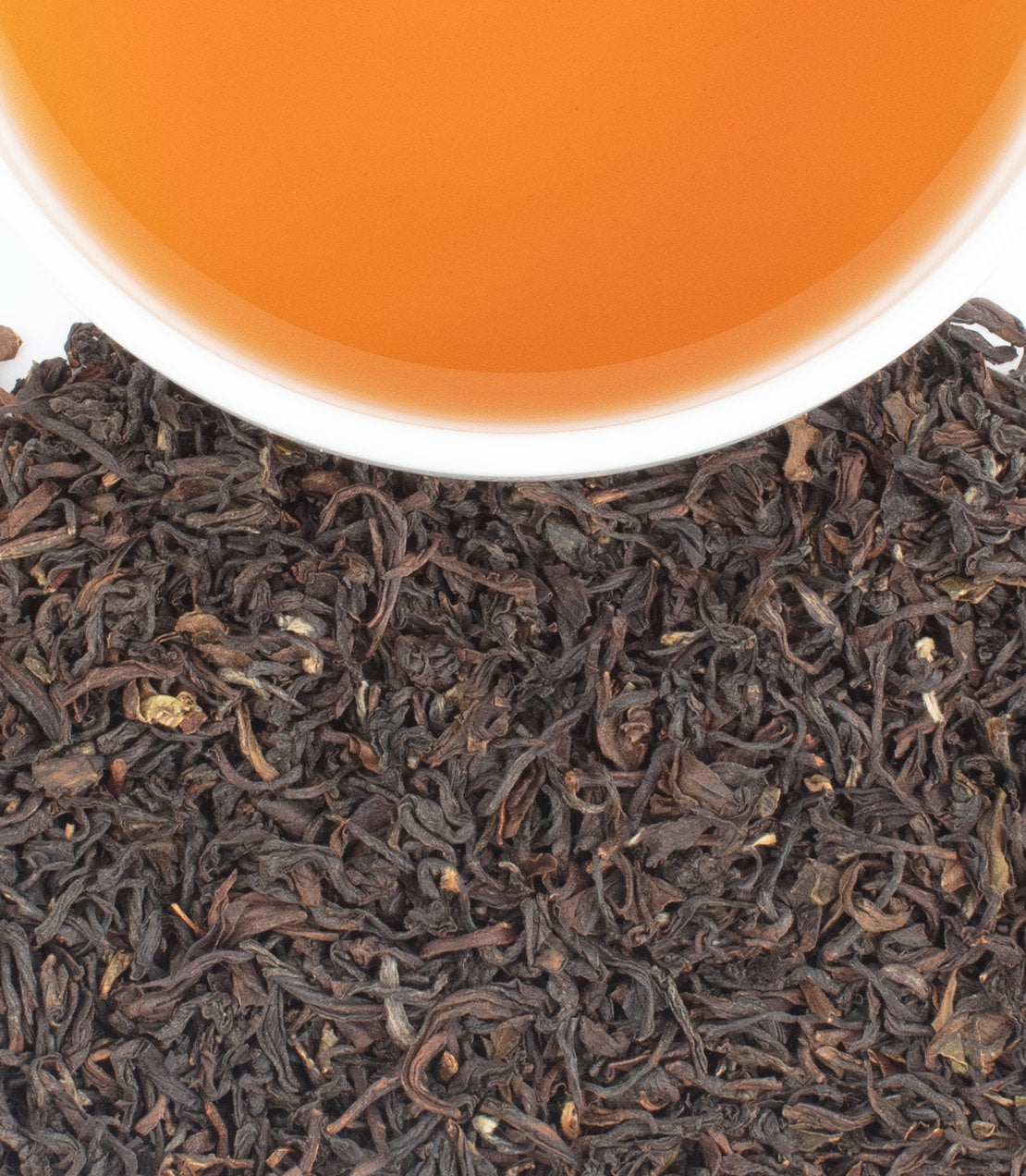 Teesta Valley 2nd Flush - - Harney & Sons Fine Teas- Overhead shot of brewed tea over loose leaves