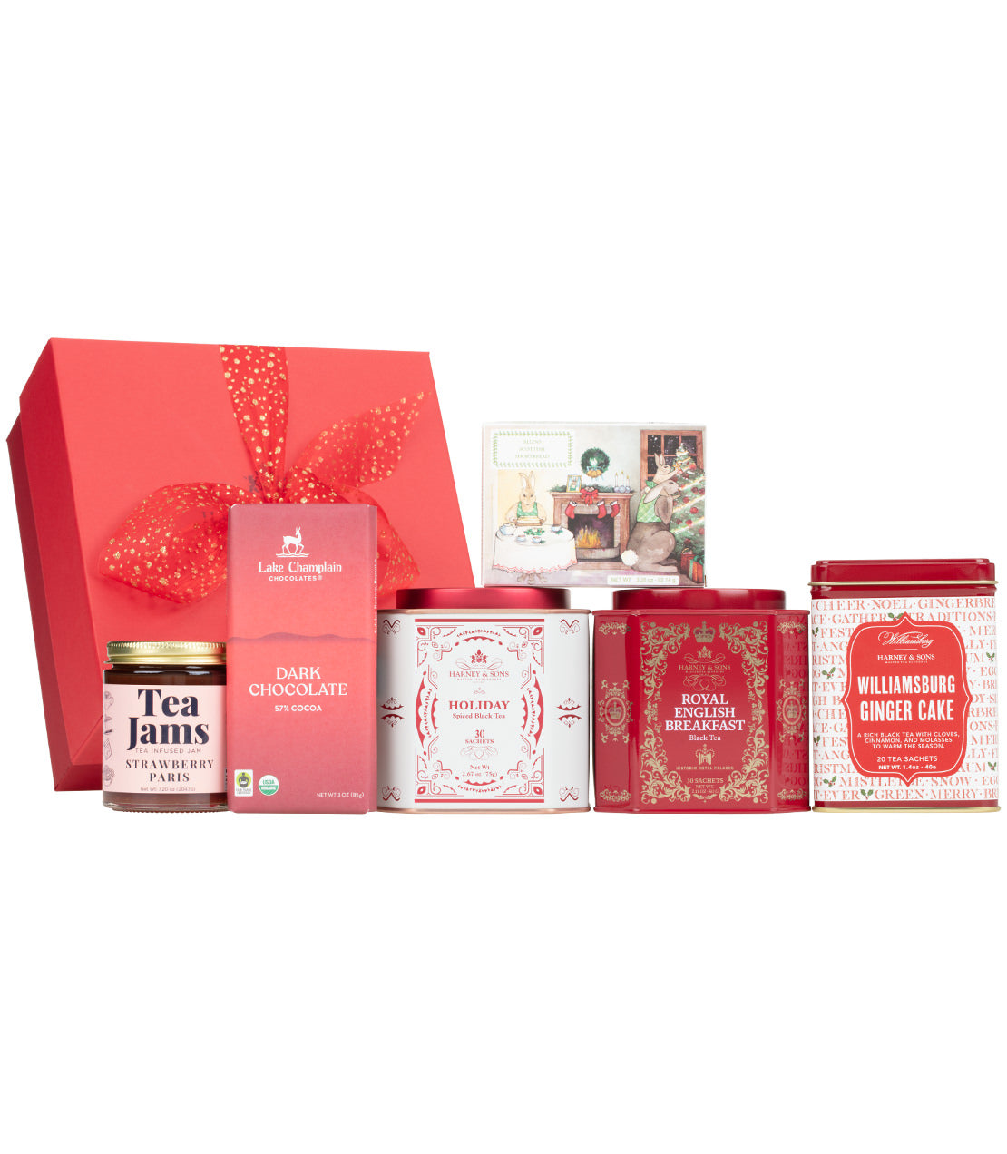 A festive gift box with a red ribbon holds assorted holiday treats including chocolate, 3 teas, jam, and a box of shortbread.