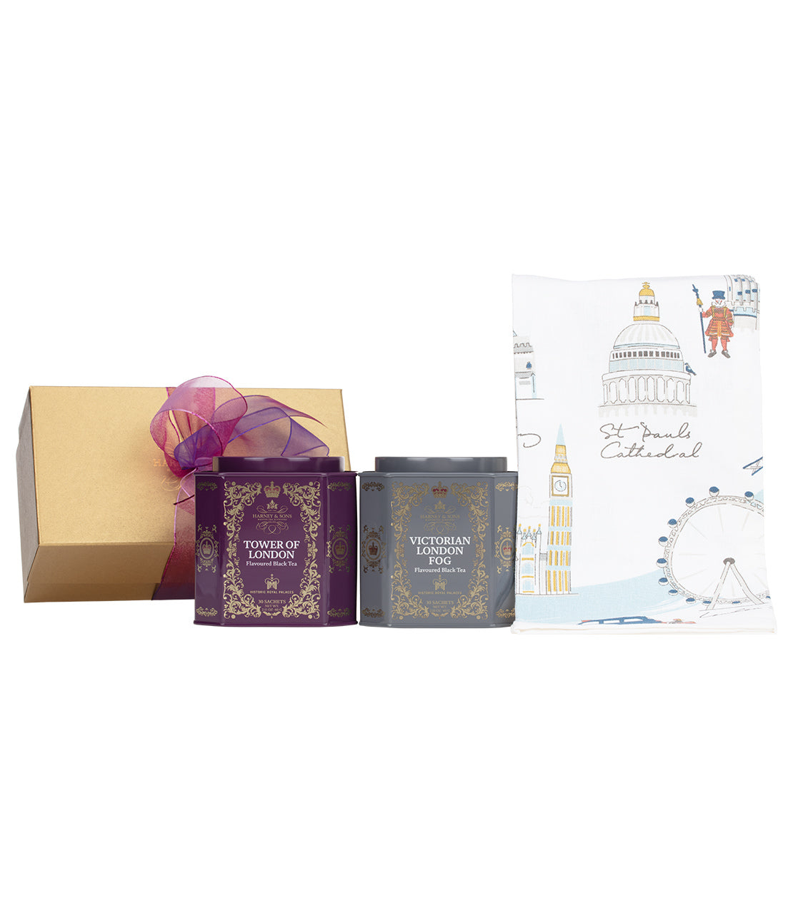 A gift set featuring two ornate tea tins labeled "Tower of London" and "Victorian London Fog," alongside a decorative cloth with London landmarks.