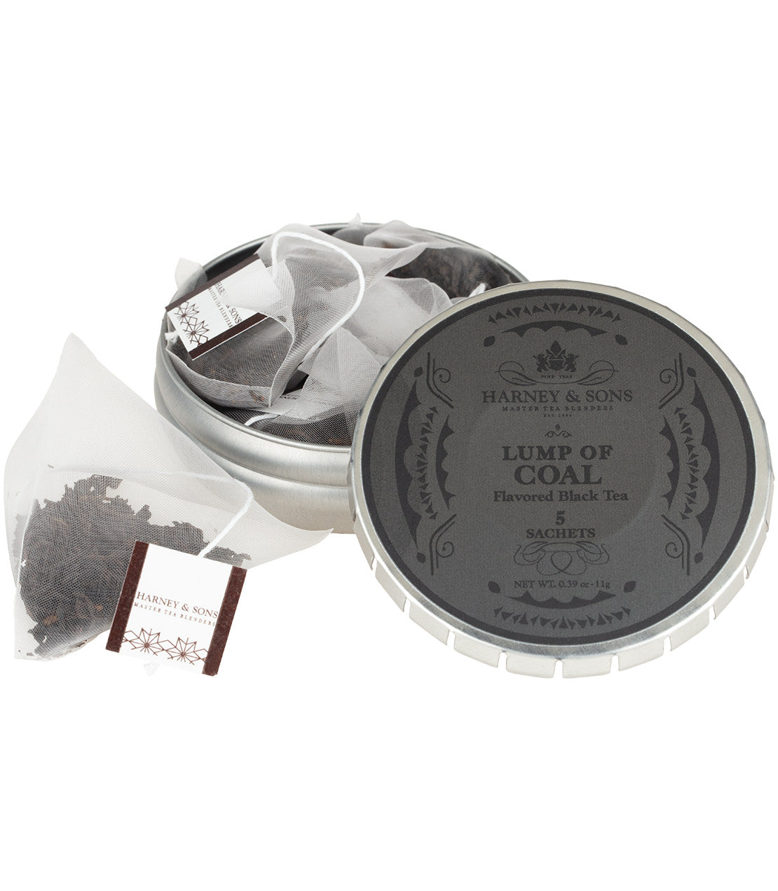 Harney & Sons Lump of Coal flavored black tea, shown in a round silver tagalong tin with the lid off, alongside one sachet on a white background.