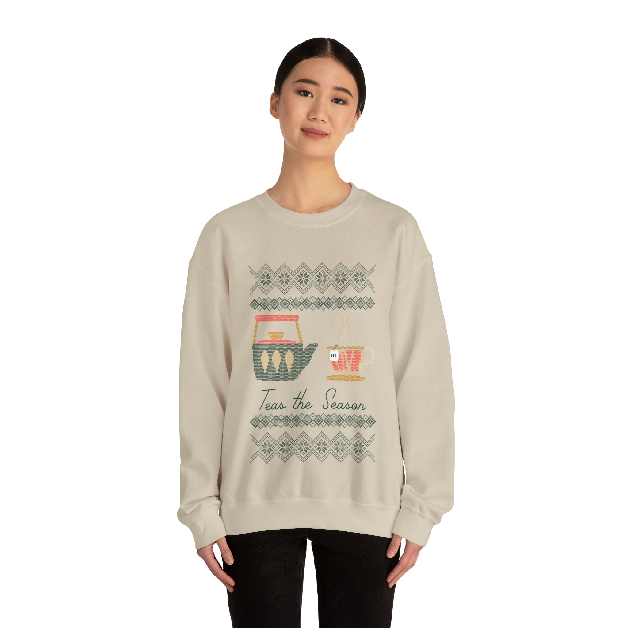 Cozy holiday sweater featuring "Teas the Season" graphic with festive tea-themed designs. Perfect for winter wear.