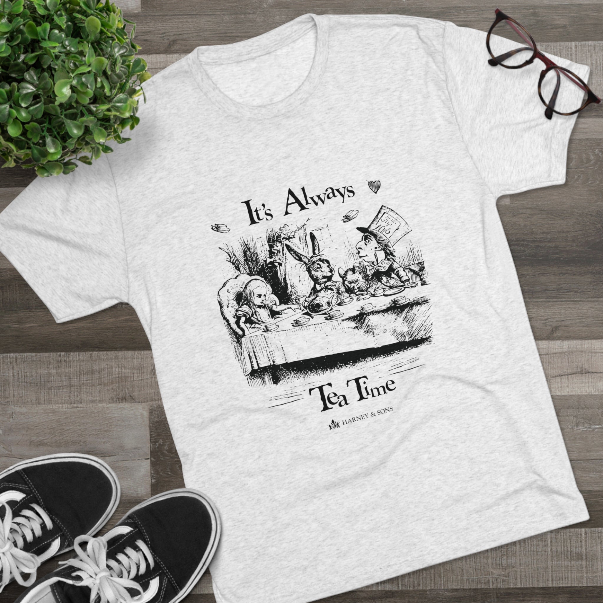 Gray graphic tee featuring "It's Always Tea Time" with whimsical illustrations of a tea party scene.