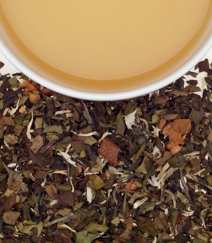 Heirloom Bartlett Pear tea sachets, featuring dried leaves and a cup of brewed tea. Perfect for a refreshing beverage.