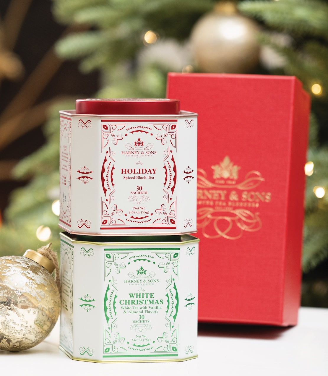 Holiday Duo Gift featuring red and green tea tins labeled "Holiday" and "White Christmas" in festive packaging.