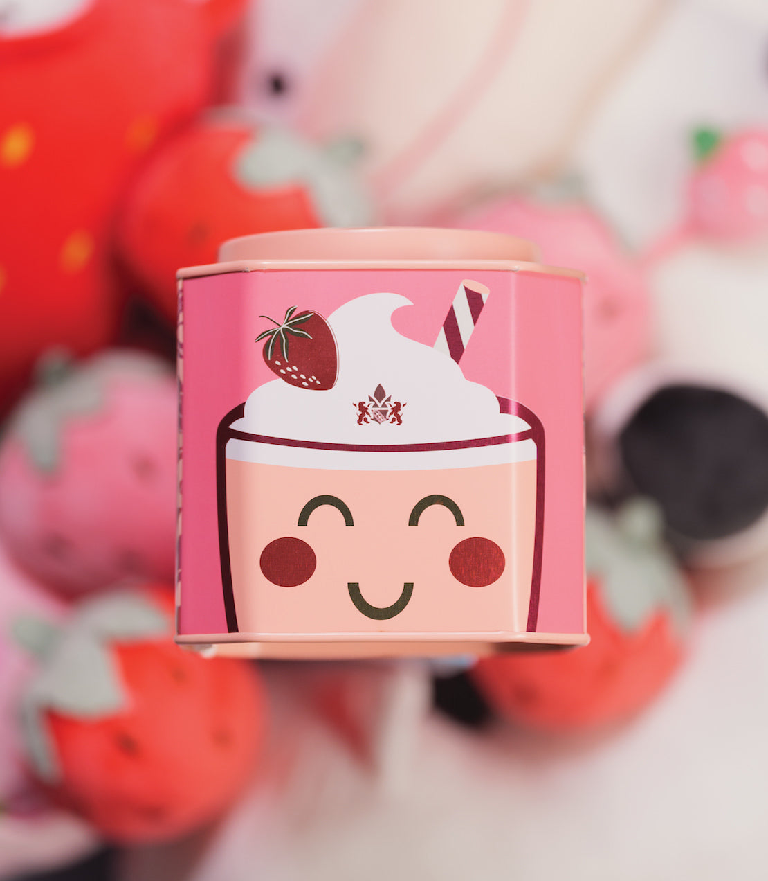Cute tin of 30 strawberry milkshake sachets featuring a smiling cup design and strawberry illustrations.