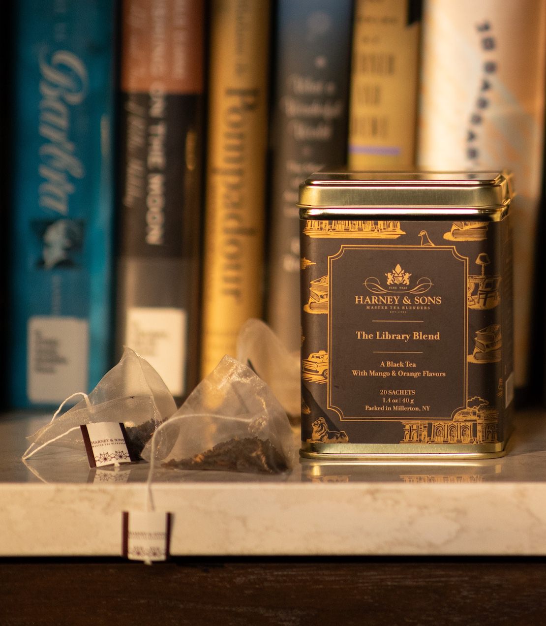 Harney & Sons Fine Teas- The Library Blend Tin of 20 sachets- Gold tin with black and gold label with tea sachets and books.