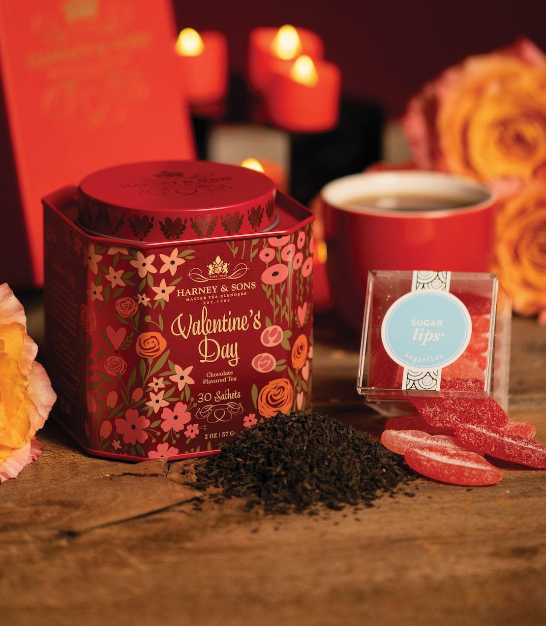 Valentine's Day gift featuring Harney & Sons tea, heart-shaped candies, and floral decorations on a rustic table.