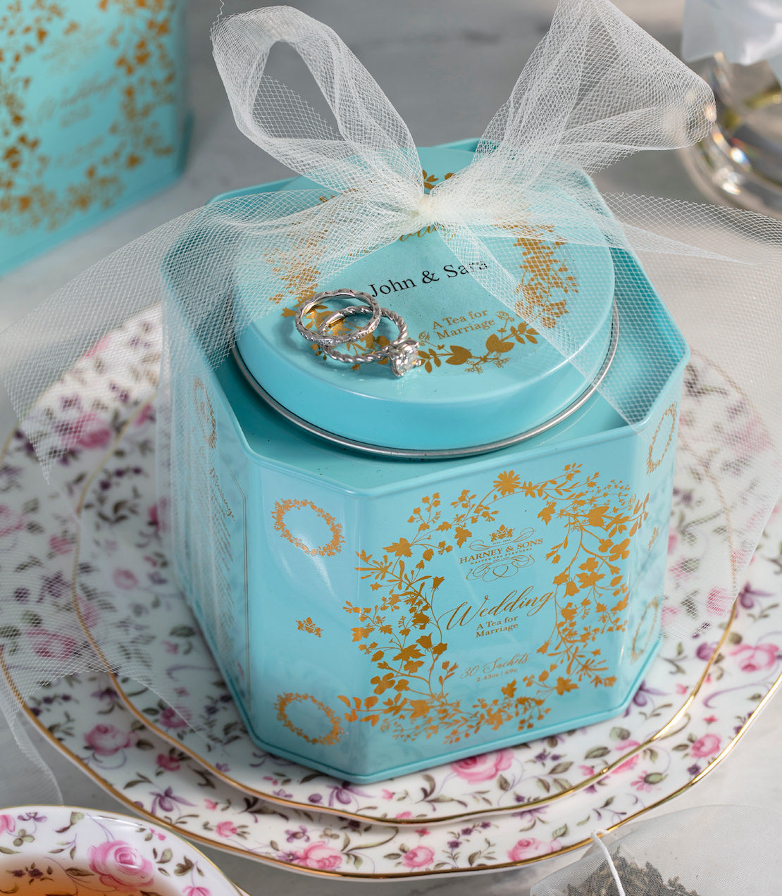 Personalized wedding tea tin featuring gold floral design, containing 30 sachets, dated August 15, 2022.