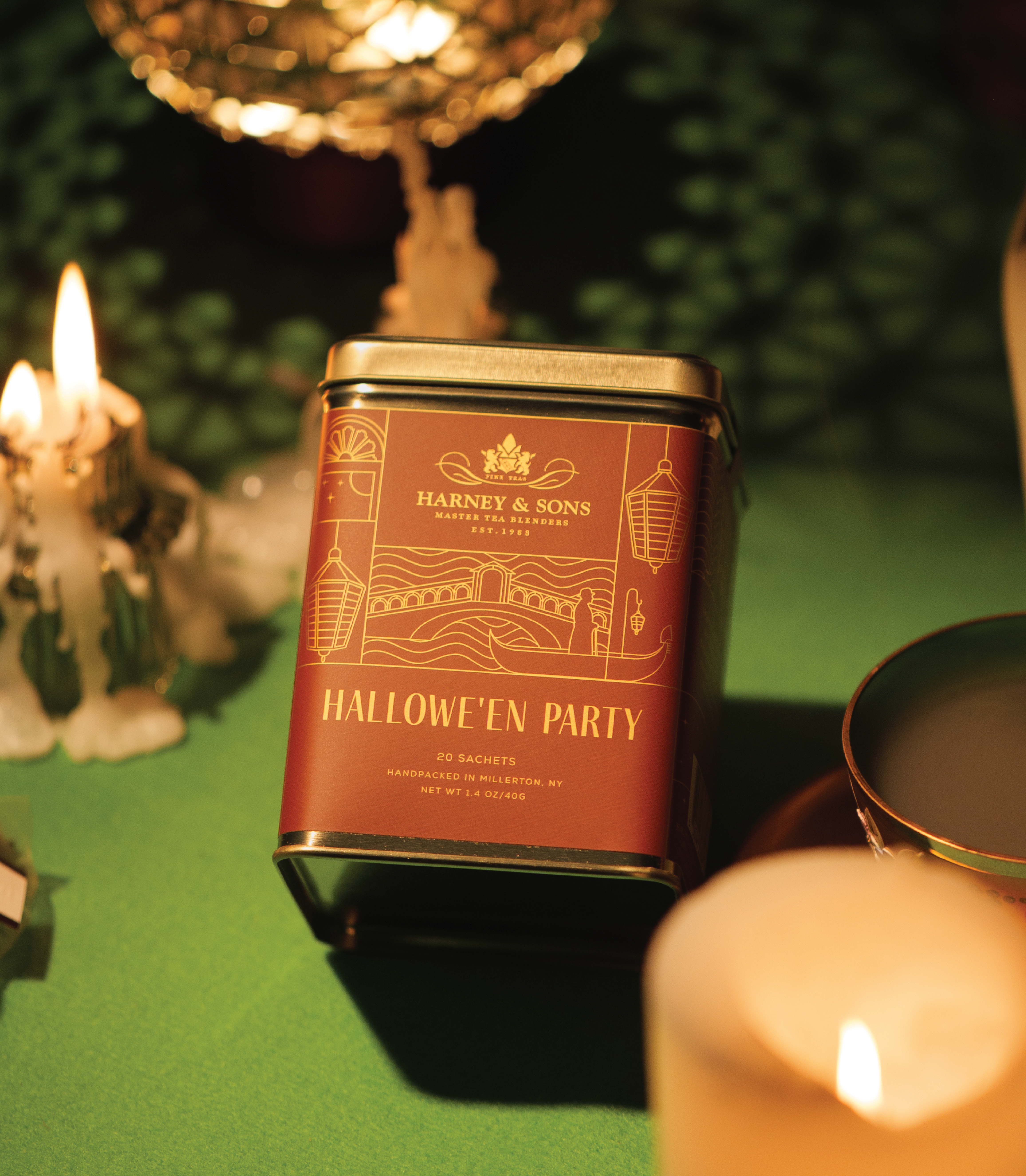 Tin of 20 Hallowe'en Party tea sachets by Harney & Sons, set on a festive table with candles and decorations.