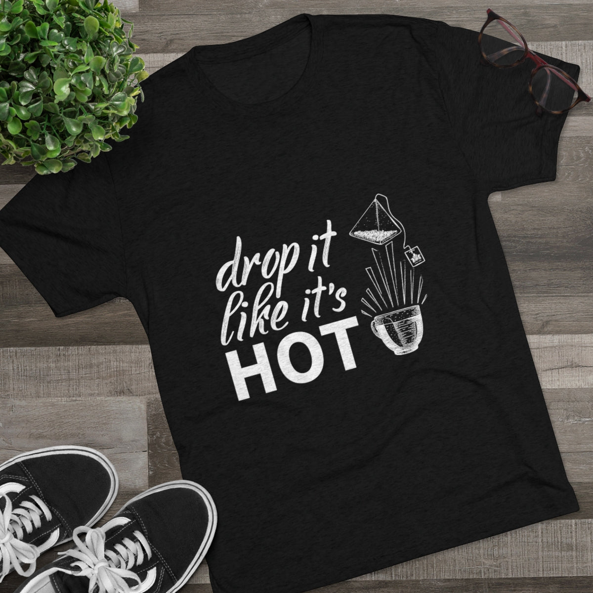Black graphic tee featuring the phrase "drop it like it's HOT" with a coffee pour-over illustration. Perfect for coffee lovers.