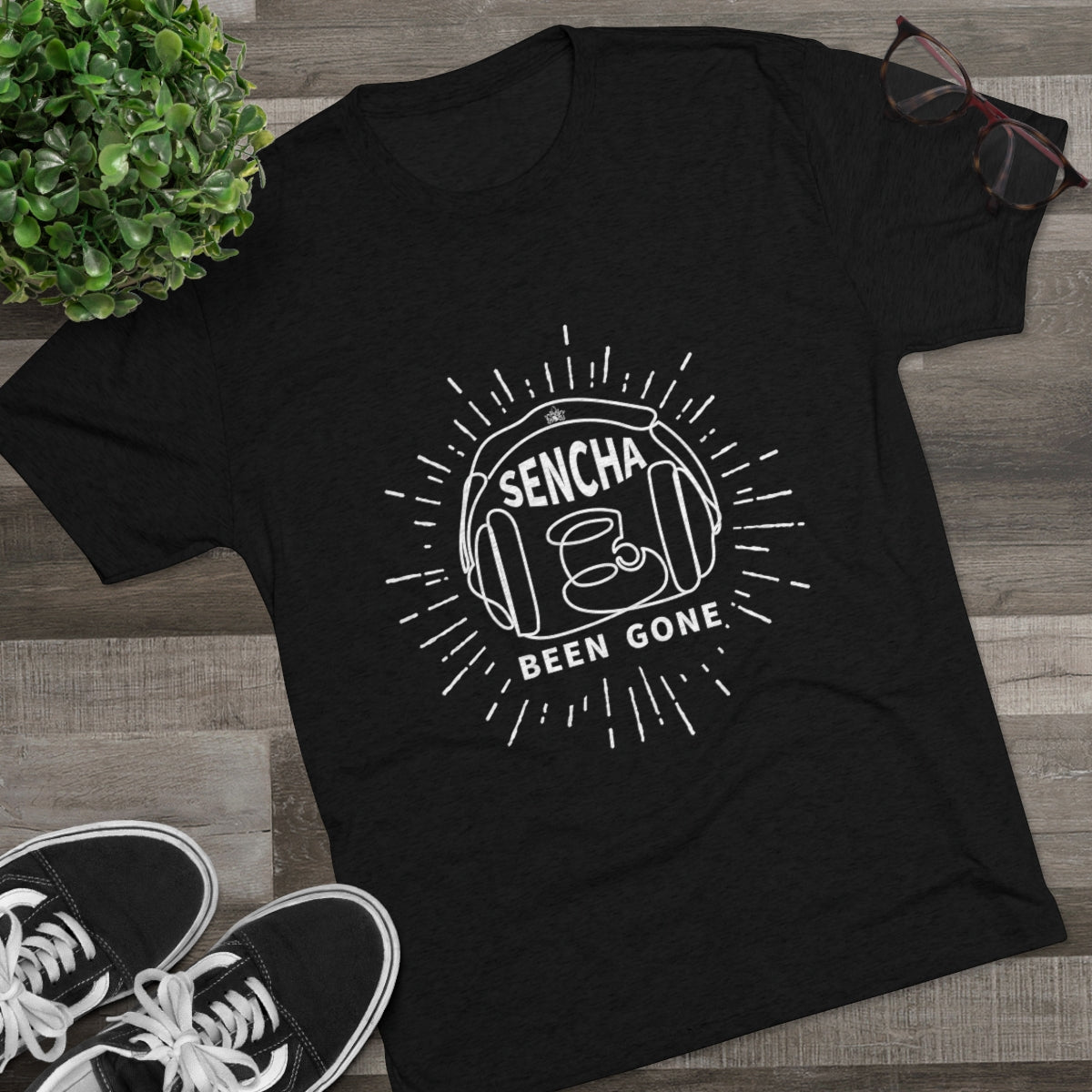 Black graphic tee featuring "Sencha Been Gone" design with a teacup and sunburst elements, styled with sneakers and glasses.