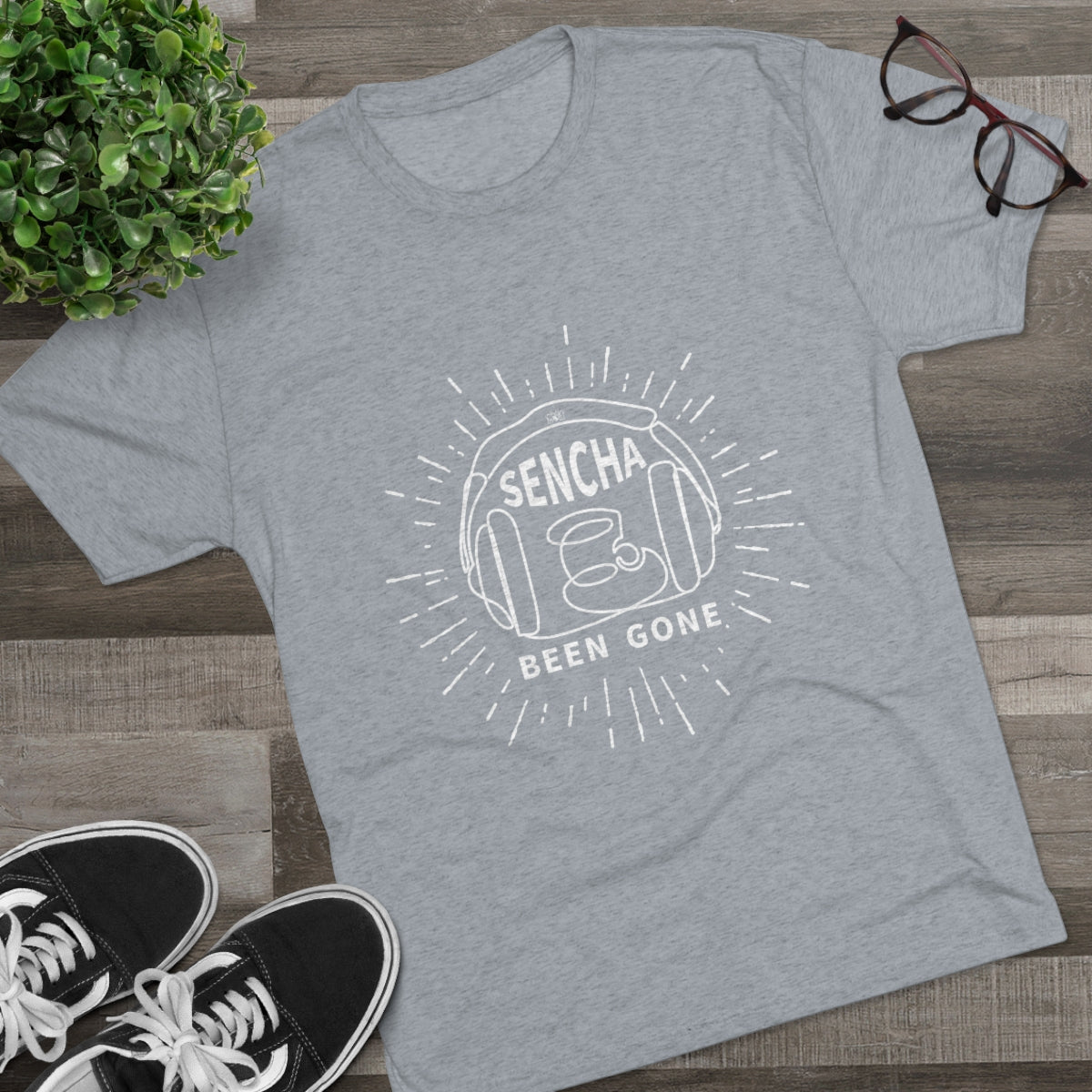 Gray graphic tee featuring "Sencha Been Gone" text and a tea cup design, styled with black sneakers and glasses.