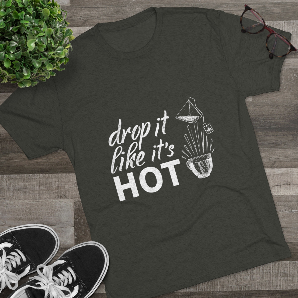 Dark green graphic tee featuring the phrase "drop it like it's HOT" with a design of a beaker and plant.