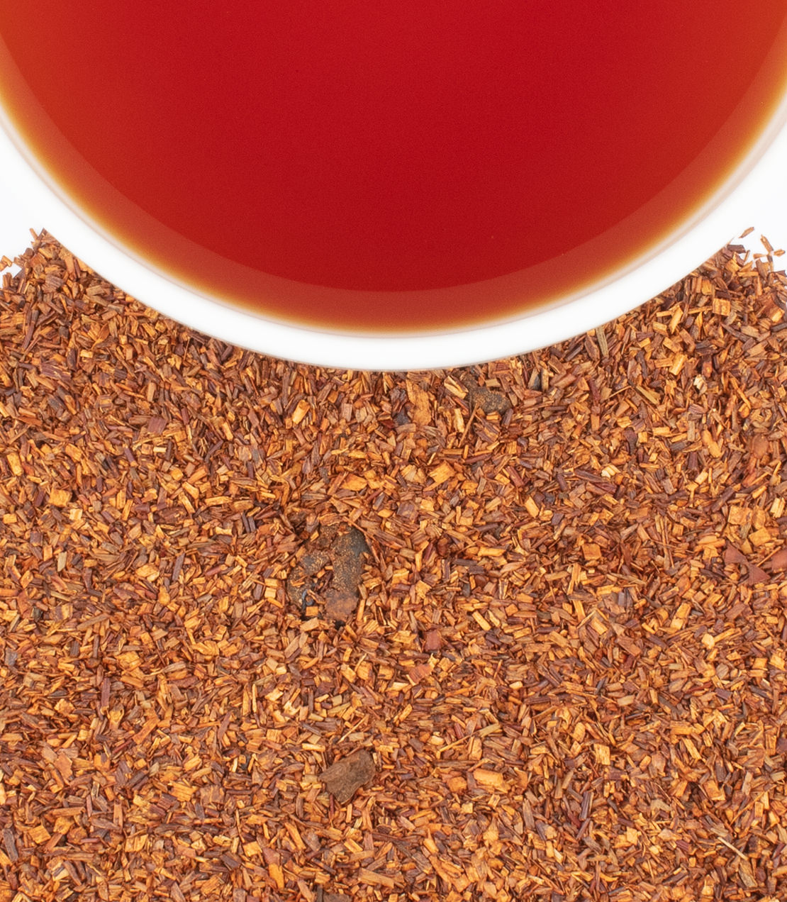 Berry Cobbler tea sachets in a tin, with loose tea leaves and a cup of brewed tea above.