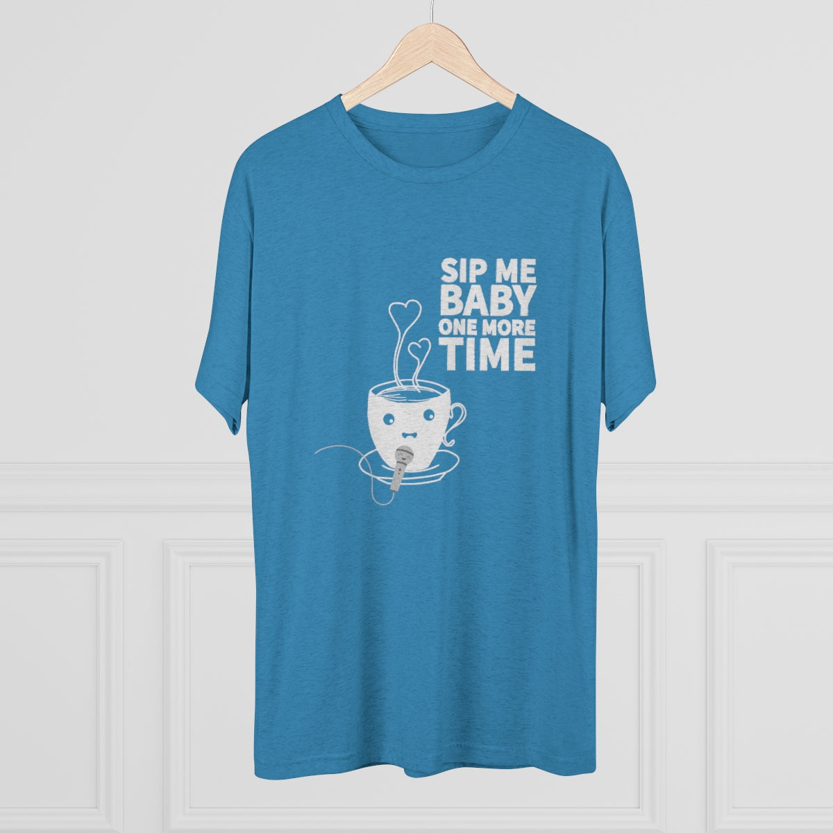 Blue graphic tee featuring the text "Sip Me Baby One More Time" with a cute cup illustration. Perfect for coffee lovers.