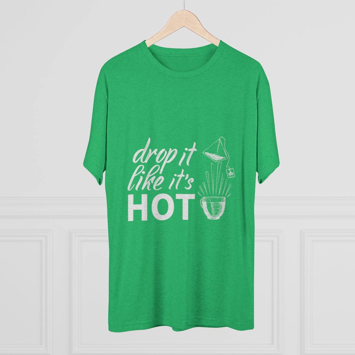 Green graphic tee featuring the phrase "drop it like it's HOT" with a playful design. Perfect for casual wear.