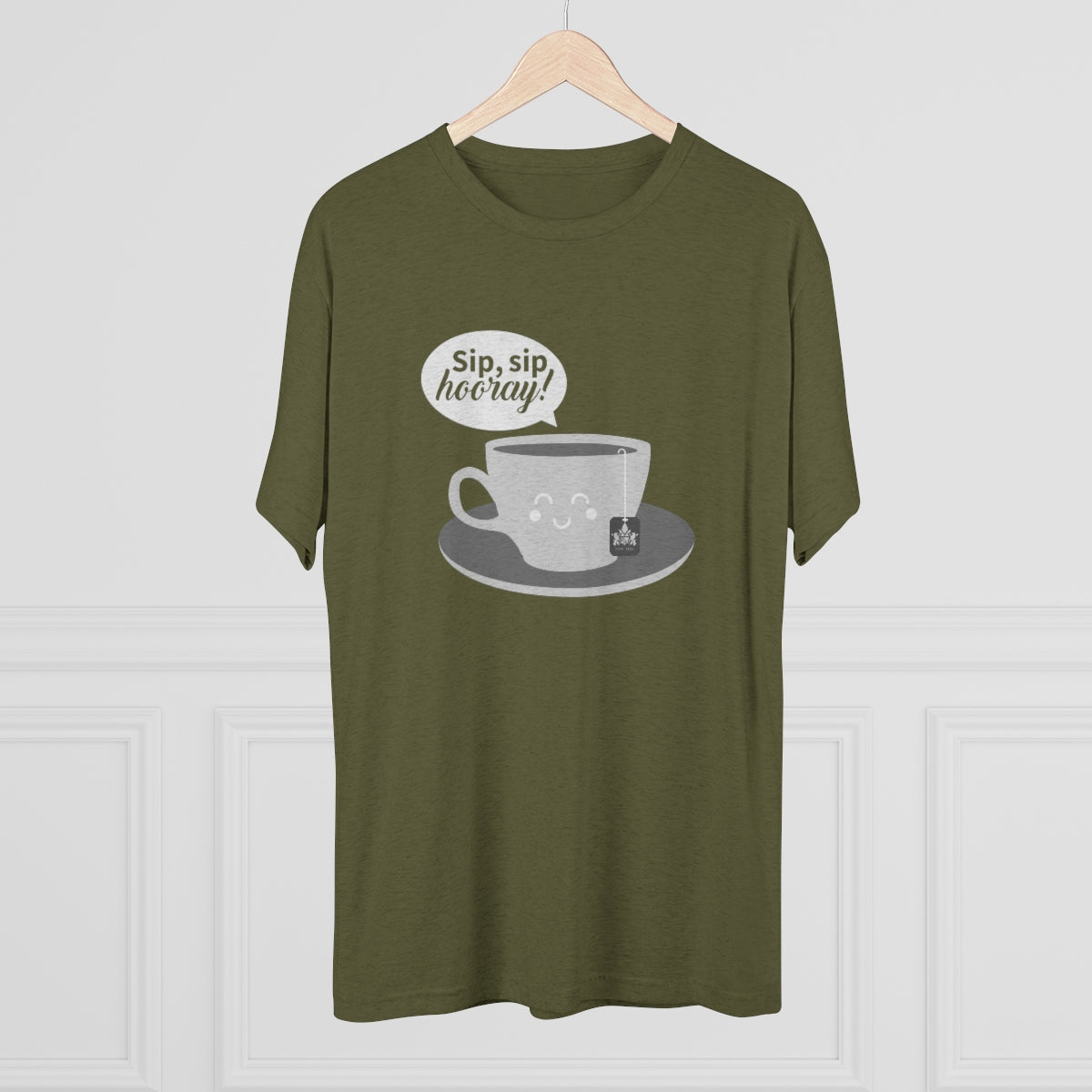 Olive green graphic tee featuring a smiling coffee cup and the text "Sip, sip, hooray!" on a white background.