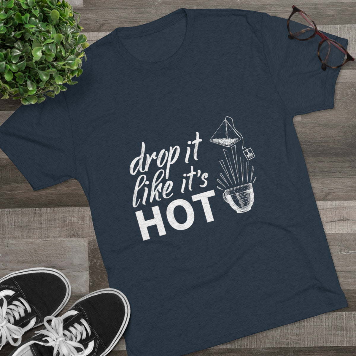 Navy graphic tee featuring the phrase "drop it like it's HOT" with a coffee filter illustration. Perfect for coffee lovers.