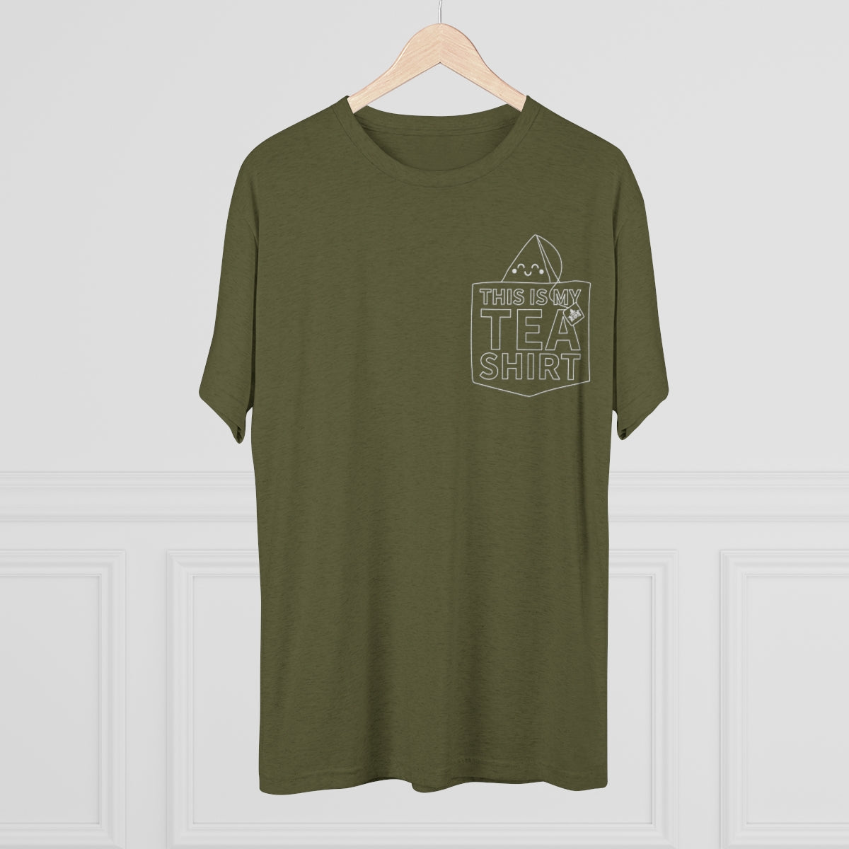 Olive green graphic tee featuring "This Is My Tea Shirt" text and a tea bag illustration on the pocket.
