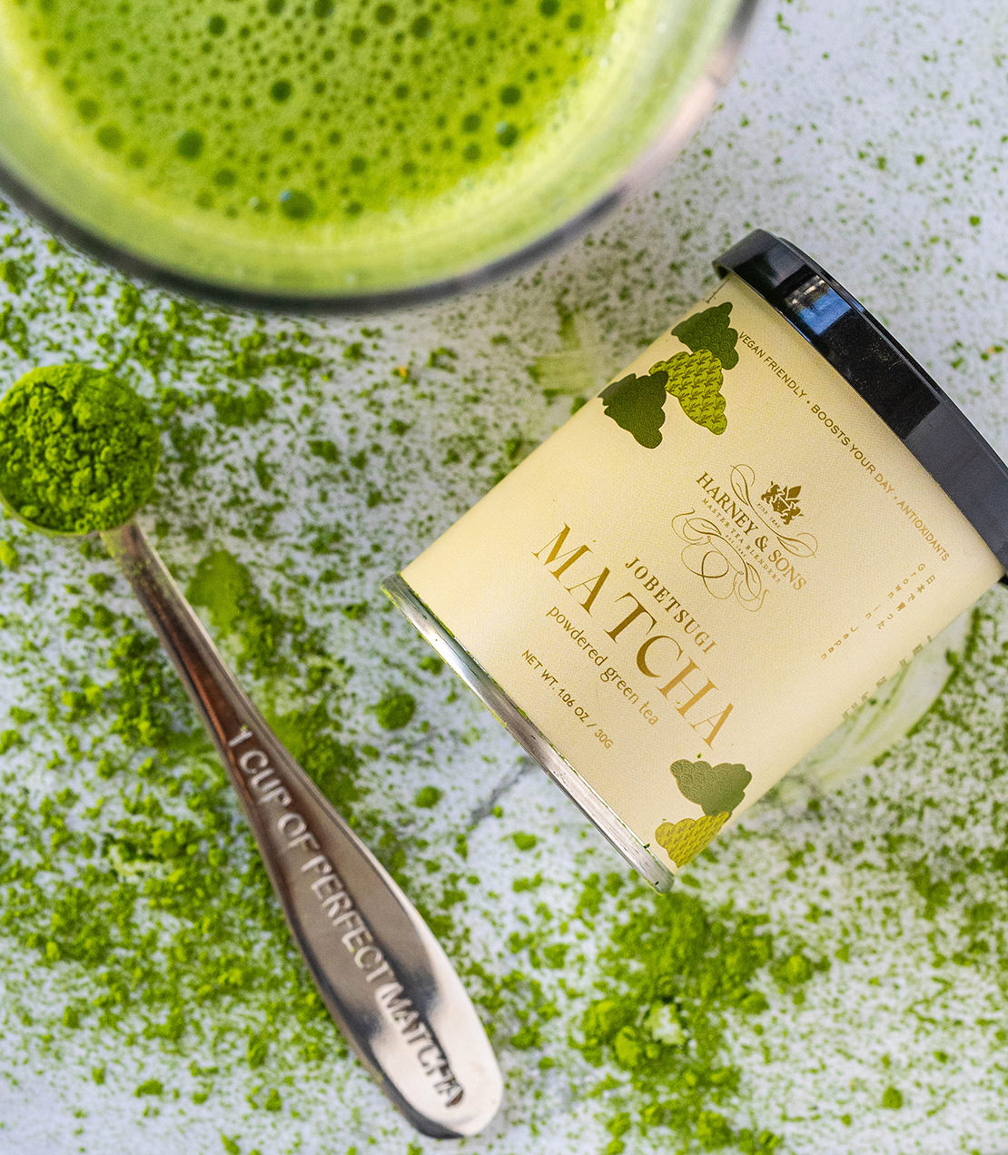 Iced Matcha Gift featuring premium matcha powder, a spoon, and vibrant green matcha drink. Perfect for tea lovers.