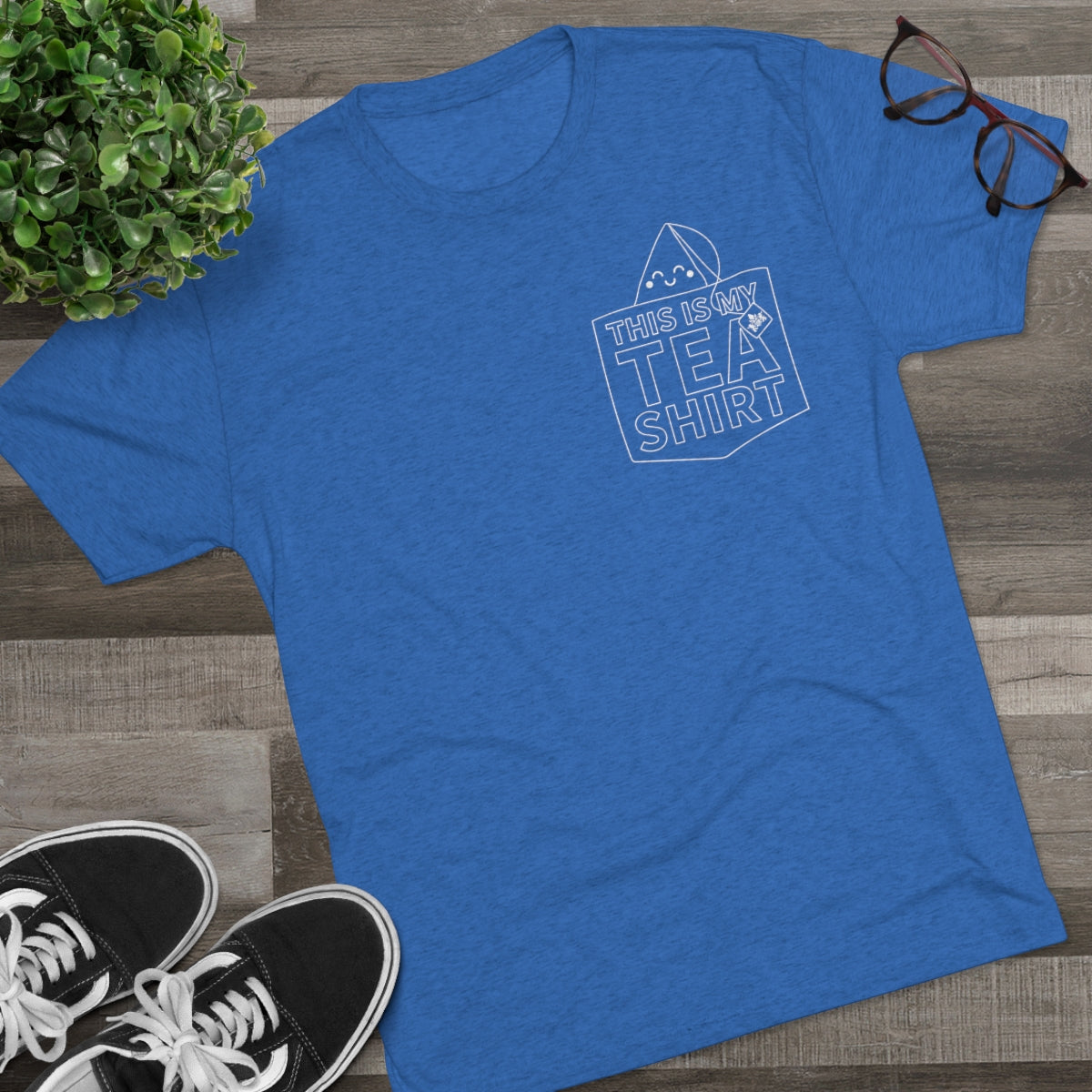 Blue graphic tee featuring the text "This Is My TEA SHIRT" with a tea bag illustration. Perfect for tea lovers.