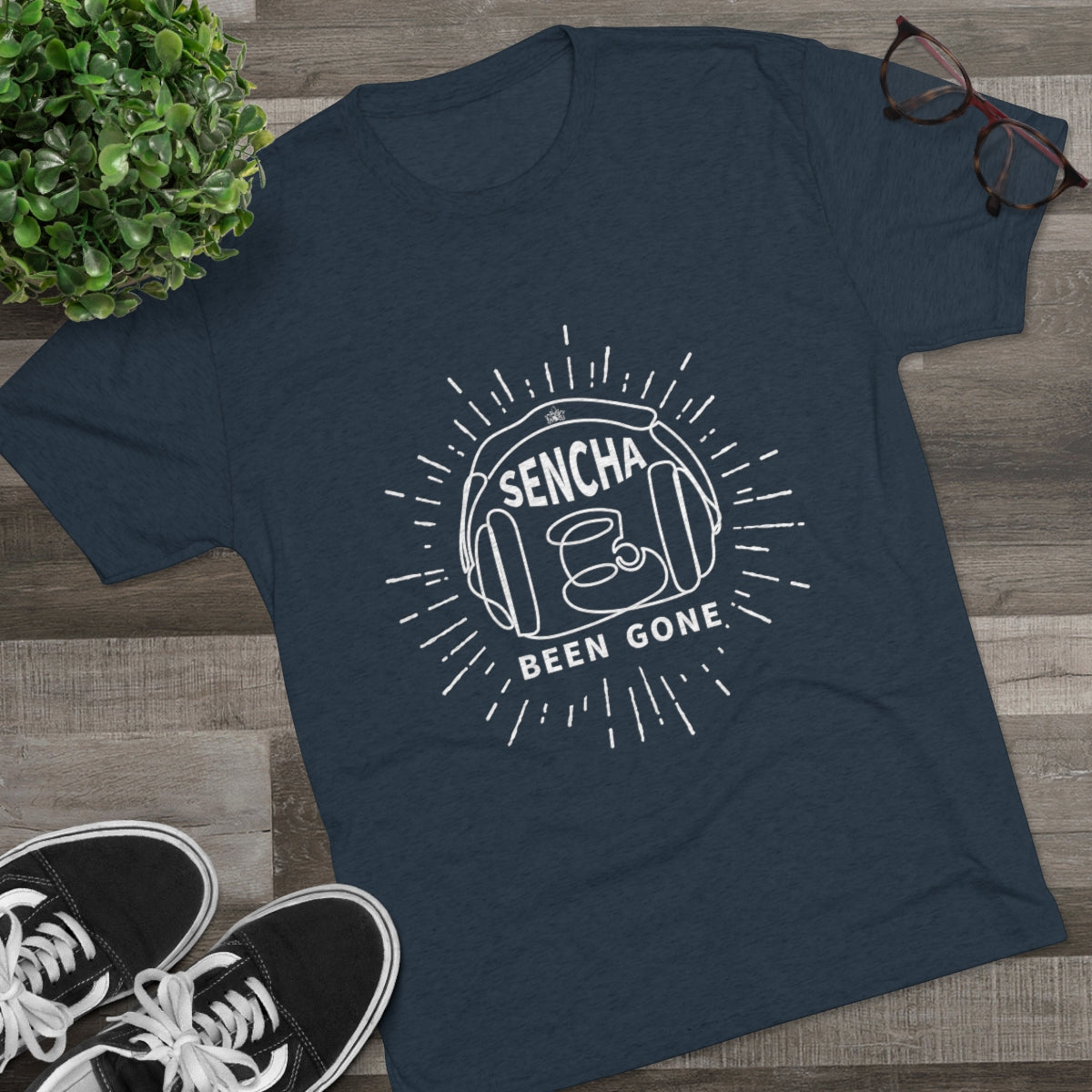 Navy graphic tee featuring "Sencha Been Gone" design with a tea cup and sunburst elements, styled with sneakers and glasses.