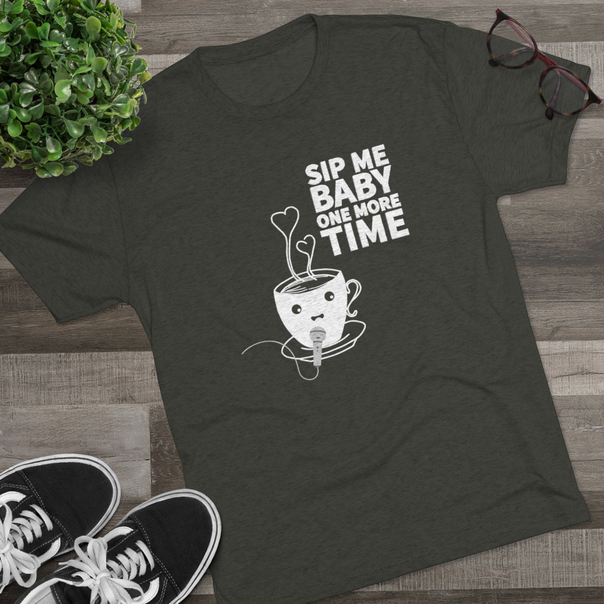 Dark green graphic tee featuring a playful coffee cup design with the text "Sip Me Baby One More Time.