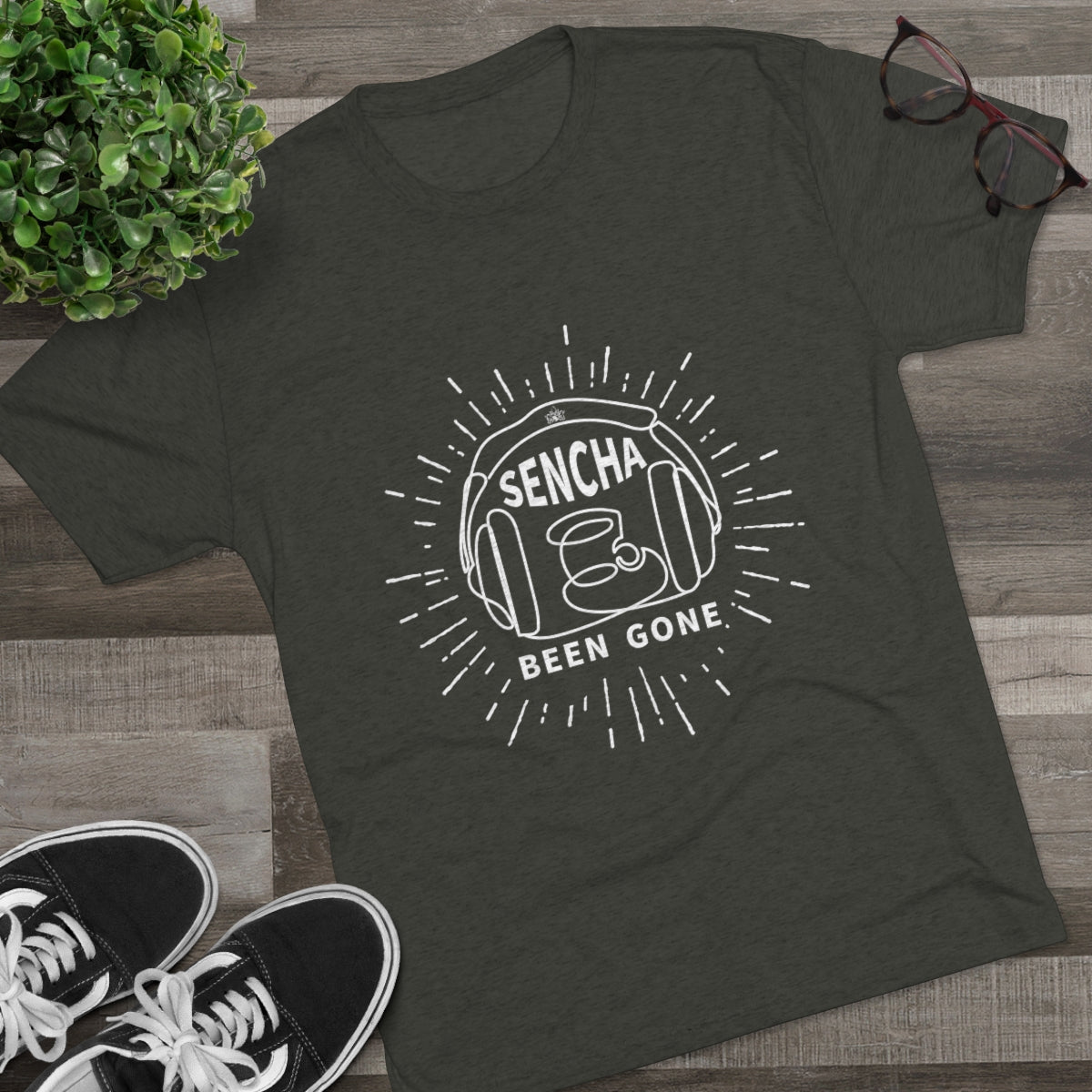 Olive green graphic tee featuring "Sencha Been Gone" design with headphones and sunburst elements.